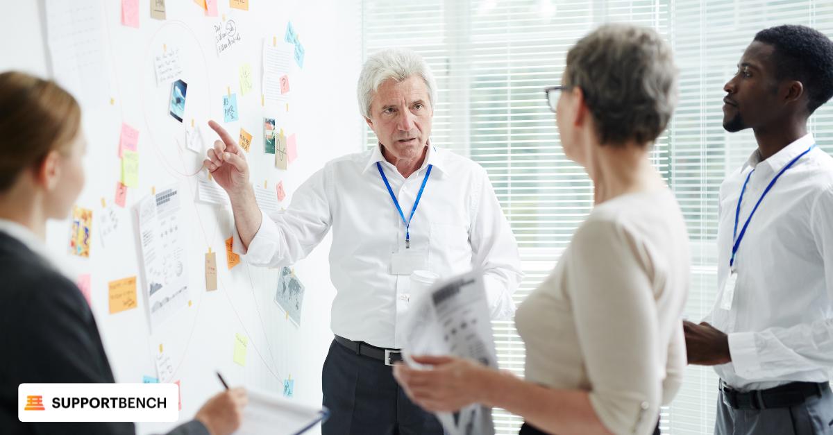 Three customer service agents seated at a table engaged in discussion with data-driven insights to enhance customer expectations